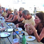 People eating and talking at picnic table