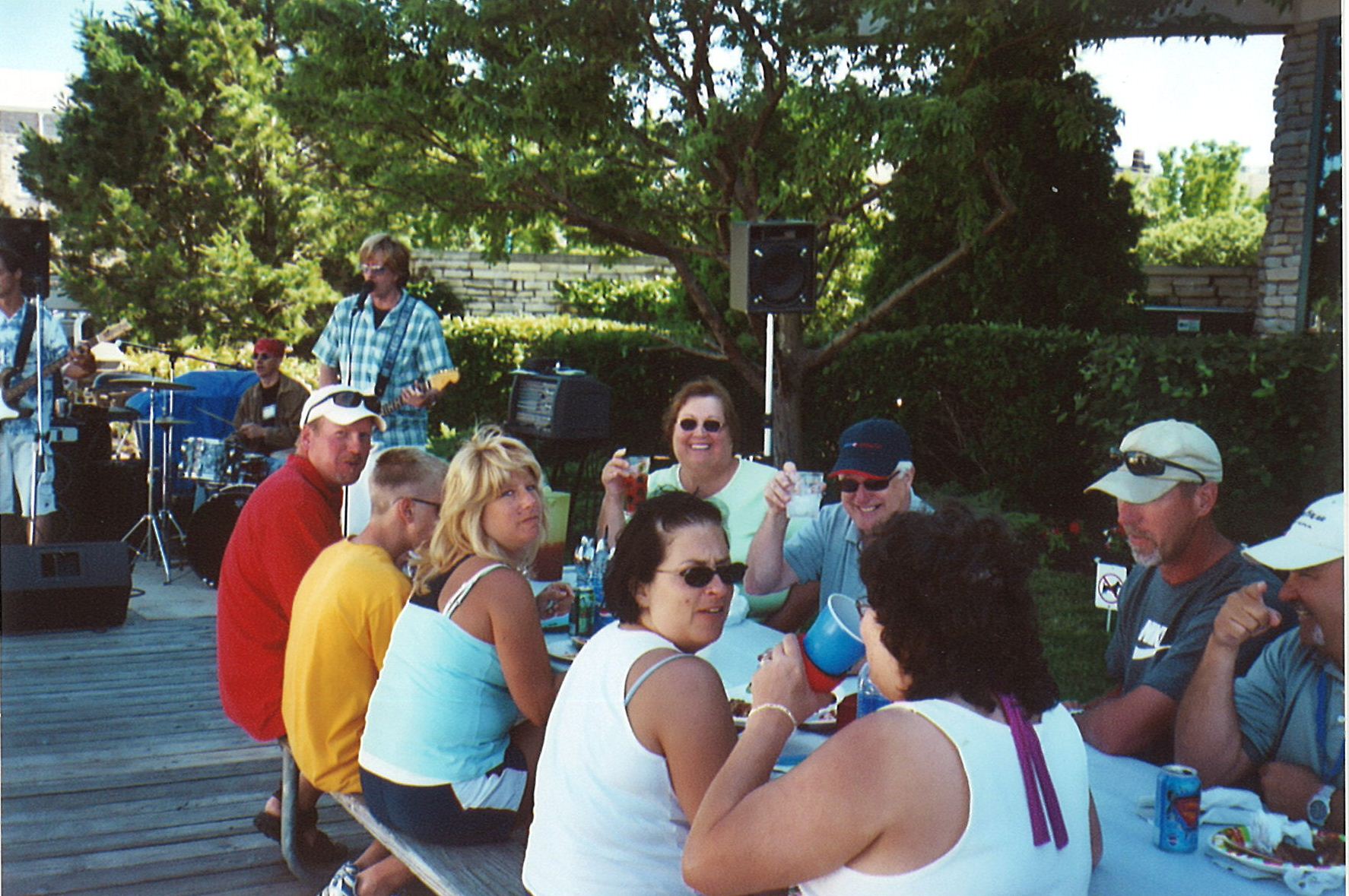 People eating and talking at picnic table